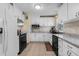 Stylish kitchen featuring white cabinets, stainless steel appliances, and chic backsplash design at 1111 King St., Myrtle Beach, SC 29577