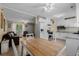 Bright, open kitchen with white cabinets, granite countertops and a connecting dining area with seating at 1111 King St., Myrtle Beach, SC 29577