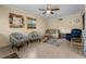 Comfortable living room featuring a loveseat, lounge chairs, ceiling fan, and unique decor at 1111 King St., Myrtle Beach, SC 29577