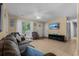 Bright living room featuring tile floors, comfortable seating, a ceiling fan, and a mounted television at 1111 King St., Myrtle Beach, SC 29577
