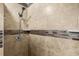 Walk-in shower includes a handheld shower head, built-in shelves, and horizontal decorative tiling at 1111 King St., Myrtle Beach, SC 29577