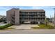 Exterior view of a multi-story condo with ground-level parking and easy access to nearby attractions at 120 Dogwood Dr. N # 209, Murrells Inlet, SC 29576