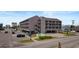 View of a multistory condo building with parking, stairs, and outdoor walkways at 120 Dogwood Dr. N # 209, Murrells Inlet, SC 29576