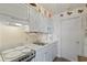 Well-maintained kitchen with white cabinetry, marble countertops, stove, and appliances at 120 Dogwood Dr. N # 209, Murrells Inlet, SC 29576