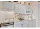 Bright kitchen featuring white cabinets, marble countertops, and modern appliances for easy meal prep at 120 Dogwood Dr. N # 209, Murrells Inlet, SC 29576