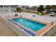 Outdoor pool area surrounded by a white fence, lounge chairs, and tropical plants creating a relaxing vacation space at 120 Dogwood Dr. N # 209, Murrells Inlet, SC 29576