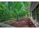 View of lush backyard with garden gate and mature trees around the home at 1204 Pine Valley Rd., North Myrtle Beach, SC 29582