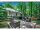 The backyard has stone floors, a seating area, a grill, and wood fencing at 1204 Pine Valley Rd., North Myrtle Beach, SC 29582