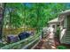 Cozy backyard with paved patio, outdoor furniture, grill, and a garden gate surrounded by lush trees at 1204 Pine Valley Rd., North Myrtle Beach, SC 29582