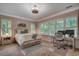 Bright bedroom featuring a ceiling fan, large windows, and a dedicated desk area for work or study at 1204 Pine Valley Rd., North Myrtle Beach, SC 29582