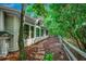 Exterior side view with a stone path amidst mulch and lush greenery along the house at 1204 Pine Valley Rd., North Myrtle Beach, SC 29582
