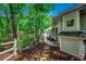 Charming home exterior with wood-paneled walls, leading to a garden gate with trees in the background at 1204 Pine Valley Rd., North Myrtle Beach, SC 29582