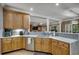 Well-lit kitchen with light wood cabinetry, light countertops, and an open view to the living area at 1204 Pine Valley Rd., North Myrtle Beach, SC 29582