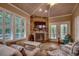 Cozy living room with a stone fireplace, vaulted ceiling, and ample seating for comfortable gatherings at 1204 Pine Valley Rd., North Myrtle Beach, SC 29582
