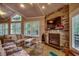 Inviting living room with a vaulted ceiling, stone fireplace, and plenty of natural light for a warm atmosphere at 1204 Pine Valley Rd., North Myrtle Beach, SC 29582