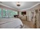 Bedroom featuring large windows, dresser, and a decorative ceiling fan at 1204 Pine Valley Rd., North Myrtle Beach, SC 29582
