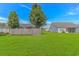 Large backyard with a well-maintained lawn and a privacy fence, great for outdoor activities and relaxation at 125 Balsa Dr., Longs, SC 29568