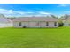 Home featuring a sprawling green lawn, ideal for outdoor activities and relaxation at 125 Balsa Dr., Longs, SC 29568