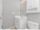 Bathroom featuring vanity with storage cabinets, plus decorative mirror and lighting at 125 Balsa Dr., Longs, SC 29568