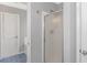 Bathroom featuring a shower, an open door, and a white door at 125 Balsa Dr., Longs, SC 29568