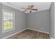A cozy bedroom featuring wood-look flooring and a ceiling fan for added comfort at 125 Balsa Dr., Longs, SC 29568