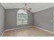Bedroom with large window, ceiling fan, tile floor, and neutral paint at 125 Balsa Dr., Longs, SC 29568
