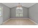 Bedroom with tile flooring, a ceiling fan, and a large window for natural light at 125 Balsa Dr., Longs, SC 29568