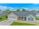 Attractive single-story home featuring blue shutters, a well-manicured lawn and a two-car garage at 125 Balsa Dr., Longs, SC 29568