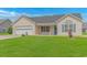 Well-maintained single-story home with blue shutters, inviting curb appeal, and a green front lawn at 125 Balsa Dr., Longs, SC 29568