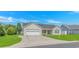 Charming single-story home with a well-manicured lawn, a two-car garage, and a welcoming blue door at 125 Balsa Dr., Longs, SC 29568
