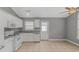 Functional kitchen featuring white appliances, a tiled floor, and access to the backyard at 125 Balsa Dr., Longs, SC 29568