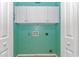 A cozy laundry room with white cabinets, a green wall, and essential utility hookups at 125 Balsa Dr., Longs, SC 29568