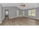 Bright living room with hardwood floors, vaulted ceilings, and access to other rooms at 125 Balsa Dr., Longs, SC 29568