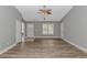 Bright living room featuring wood floors, large window, and a ceiling fan with light fixture at 125 Balsa Dr., Longs, SC 29568