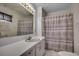 This bathroom features a shower and a single sink with a large mirror above at 1261 Parkhill Dr., Conway, SC 29526