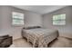 This bedroom features a bed under two windows and is carpeted at 1261 Parkhill Dr., Conway, SC 29526