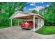 Carport featuring a car inside, wooden roof supports, and landscaping at 1261 Parkhill Dr., Conway, SC 29526