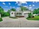 Exterior view of a well-maintained home with a driveway, carport, and green lawn at 1261 Parkhill Dr., Conway, SC 29526