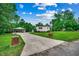 Home with a long driveway, attached carport, well-maintained lawn and brick accent columns at 1261 Parkhill Dr., Conway, SC 29526