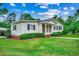 Charming one-story home with a well-manicured lawn, brick foundation and walkway at 1261 Parkhill Dr., Conway, SC 29526