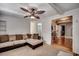 The living room features a ceiling fan and a sectional sofa that faces a doorway at 1261 Parkhill Dr., Conway, SC 29526