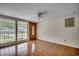 Bright living room with hardwood floors, large windows, and front door view at 1261 Parkhill Dr., Conway, SC 29526