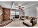 The living room features a brick fireplace, a TV, a ceiling fan, and a sectional sofa at 1261 Parkhill Dr., Conway, SC 29526