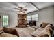 The living room features a brick fireplace, a large TV, a ceiling fan, and a sectional sofa at 1261 Parkhill Dr., Conway, SC 29526