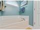 Relaxing bathroom featuring an enclosed bathtub and small window allowing natural light at 127 Pinfeather Trail, Myrtle Beach, SC 29588