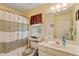 Bathroom with shower and tub, sink and cabinet, toilet, window, and other amenities at 127 Pinfeather Trail, Myrtle Beach, SC 29588