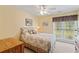 Cozy bedroom with ceiling fan and large window providing plenty of natural light at 127 Pinfeather Trail, Myrtle Beach, SC 29588