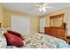 Bedroom with ceiling fan, closet space, a dresser with a mirror, and a bed at 127 Pinfeather Trail, Myrtle Beach, SC 29588