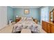 Comfortable bedroom featuring neutral walls, floral bedspread, and classic wooden furniture at 127 Pinfeather Trail, Myrtle Beach, SC 29588