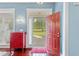 Stylish entryway with a red door, hardwood floors, and blue walls, creating a warm welcome at 127 Pinfeather Trail, Myrtle Beach, SC 29588